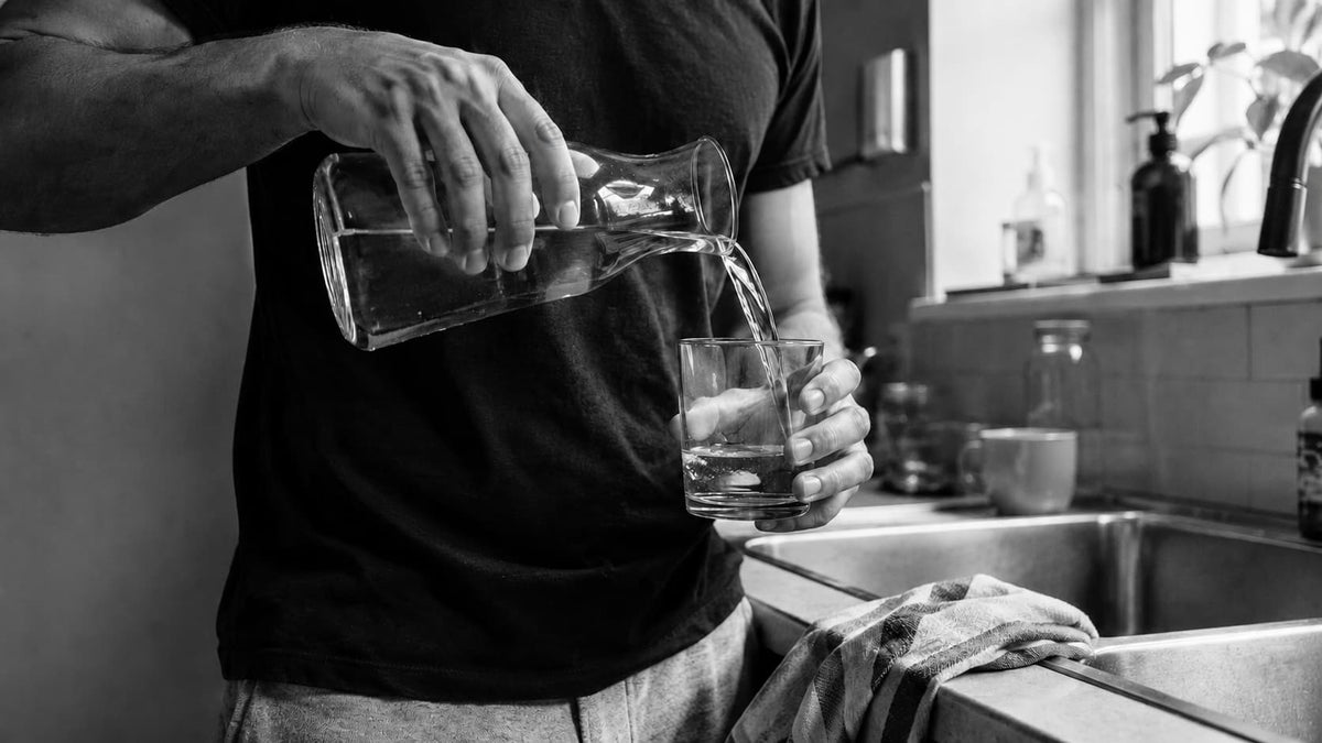 Person lying in bed representing poor sleep after drinking